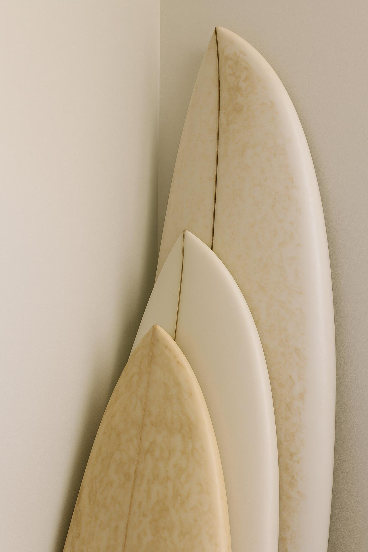 Colorful surfboard collection on stained plywood background