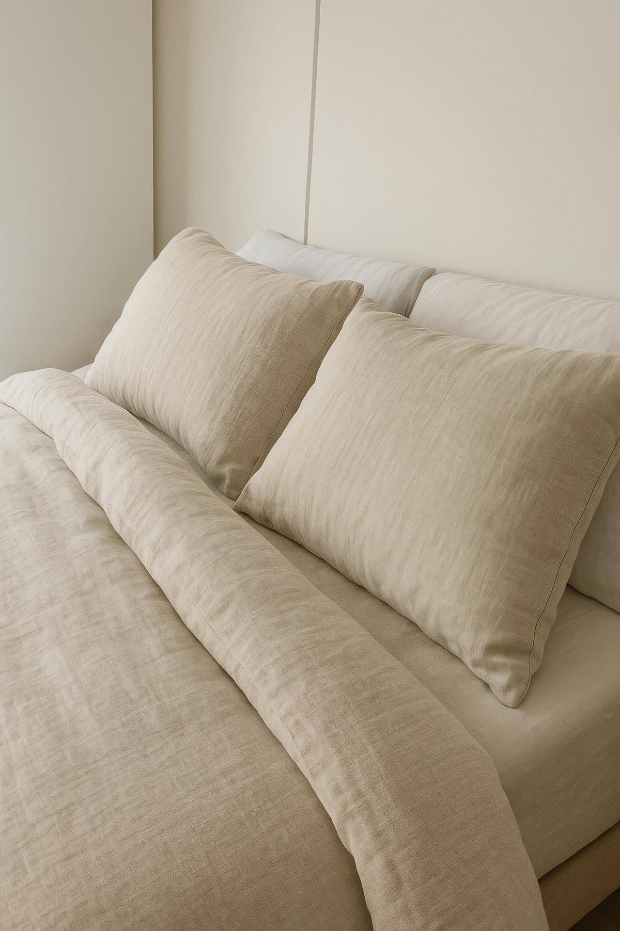Bedroom with bed, linens, pillows, duvet, throw pillow, lamp, sofa
