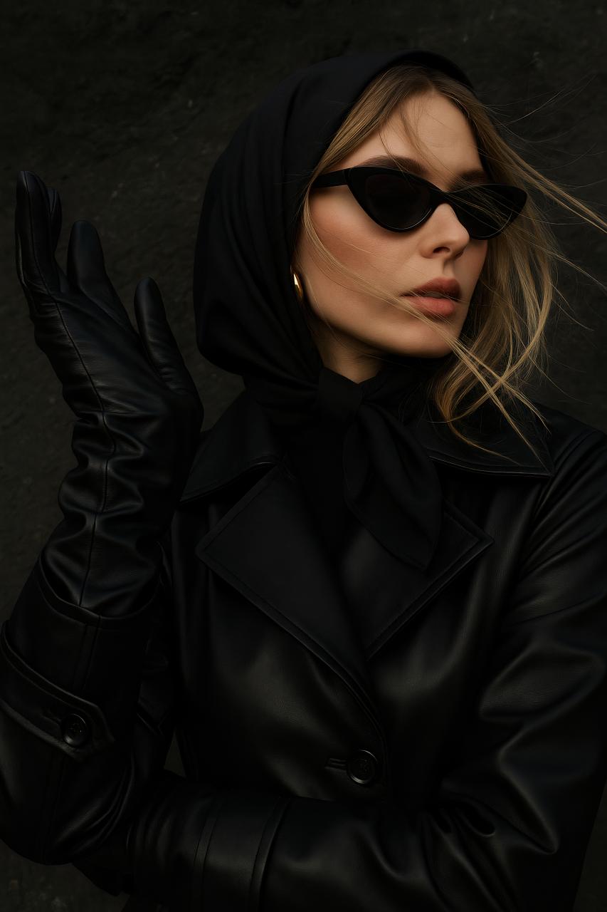 Fashion model in black leather jacket, sunglasses, and goggles
