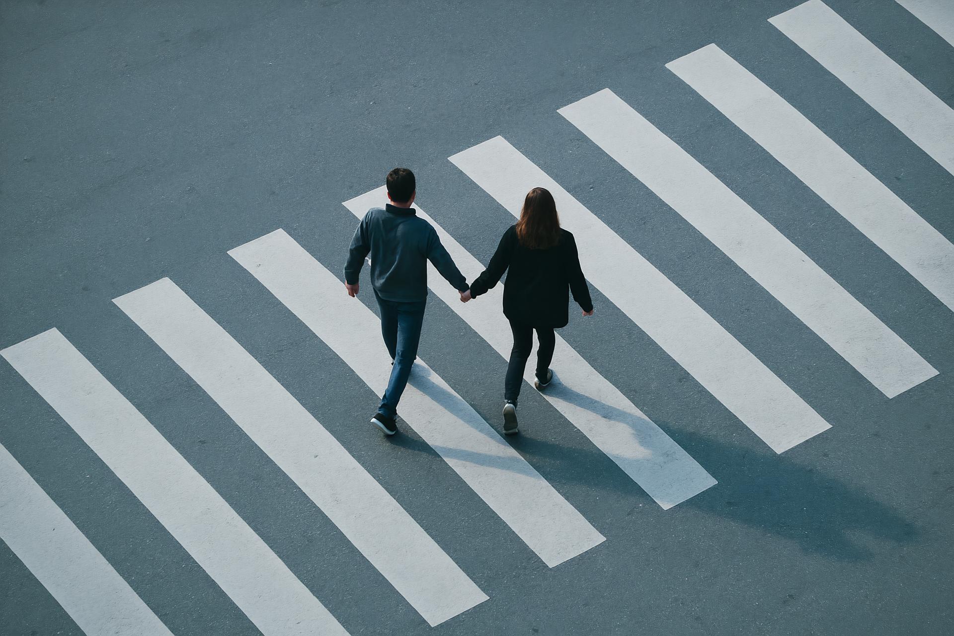 Pedestrians holding hands at zebra crossing near Mid Valley Megamall