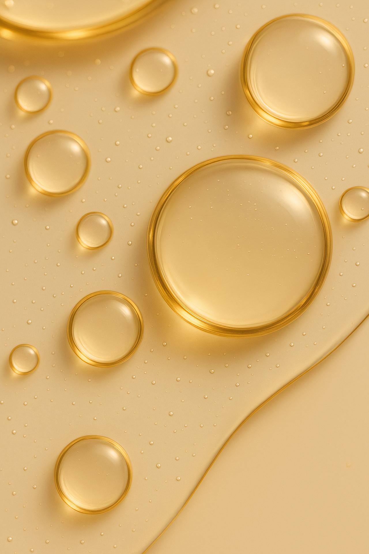Yellow liquid drop with bubbles, high-resolution stock photo