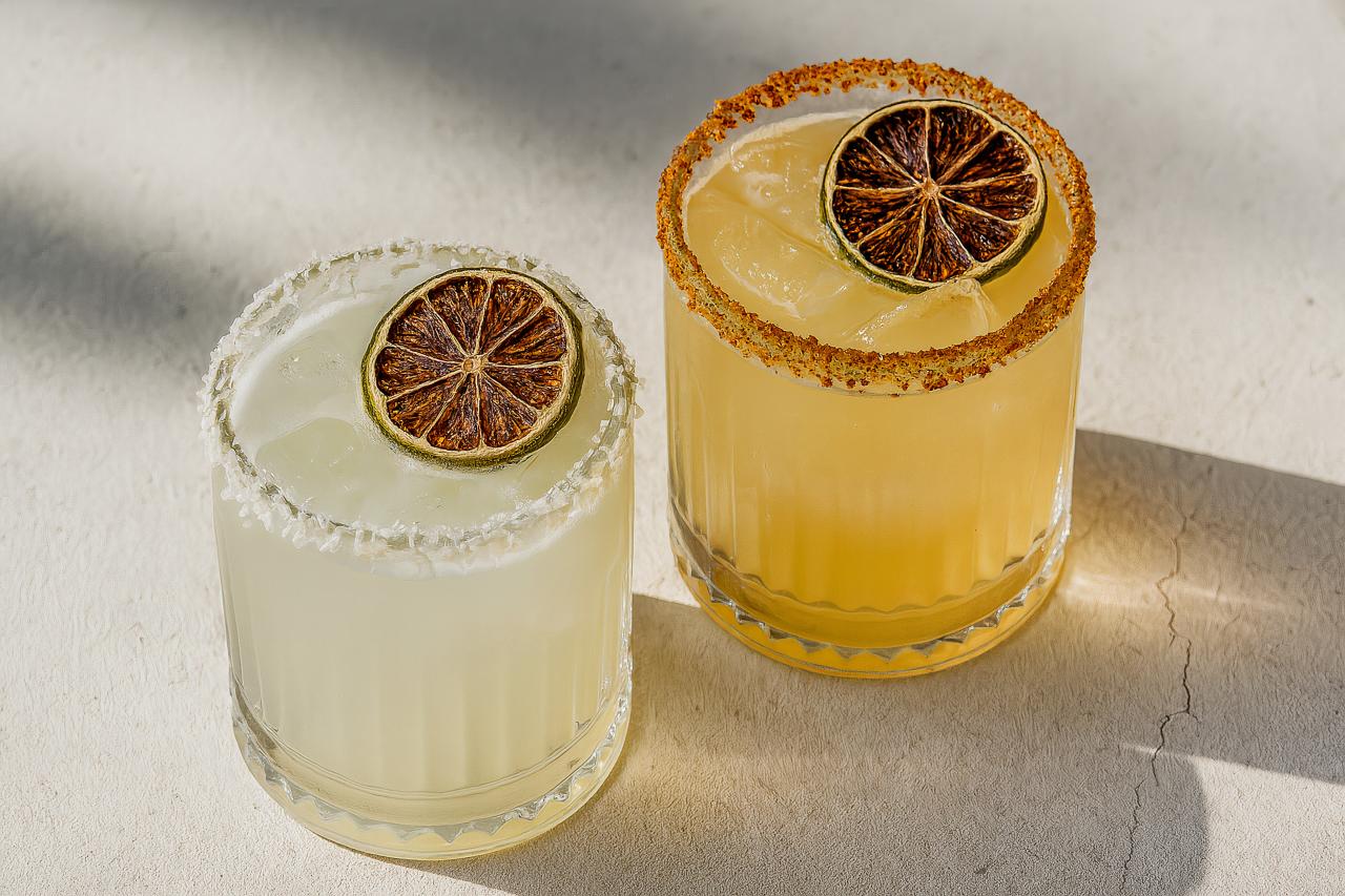 Tableware with cocktails, garnishes, and drinks