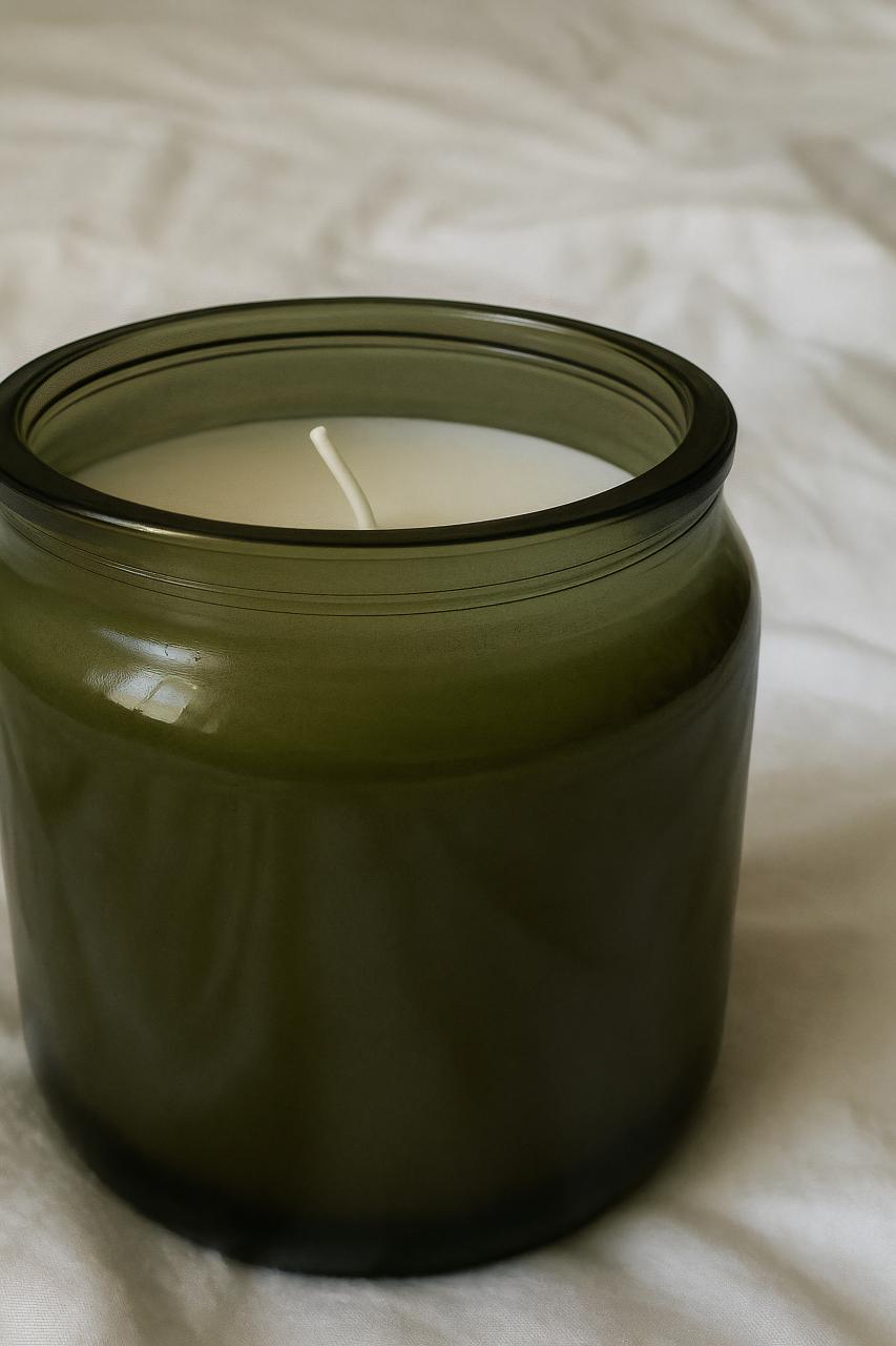Candle in mason jar with wax and food storage containers