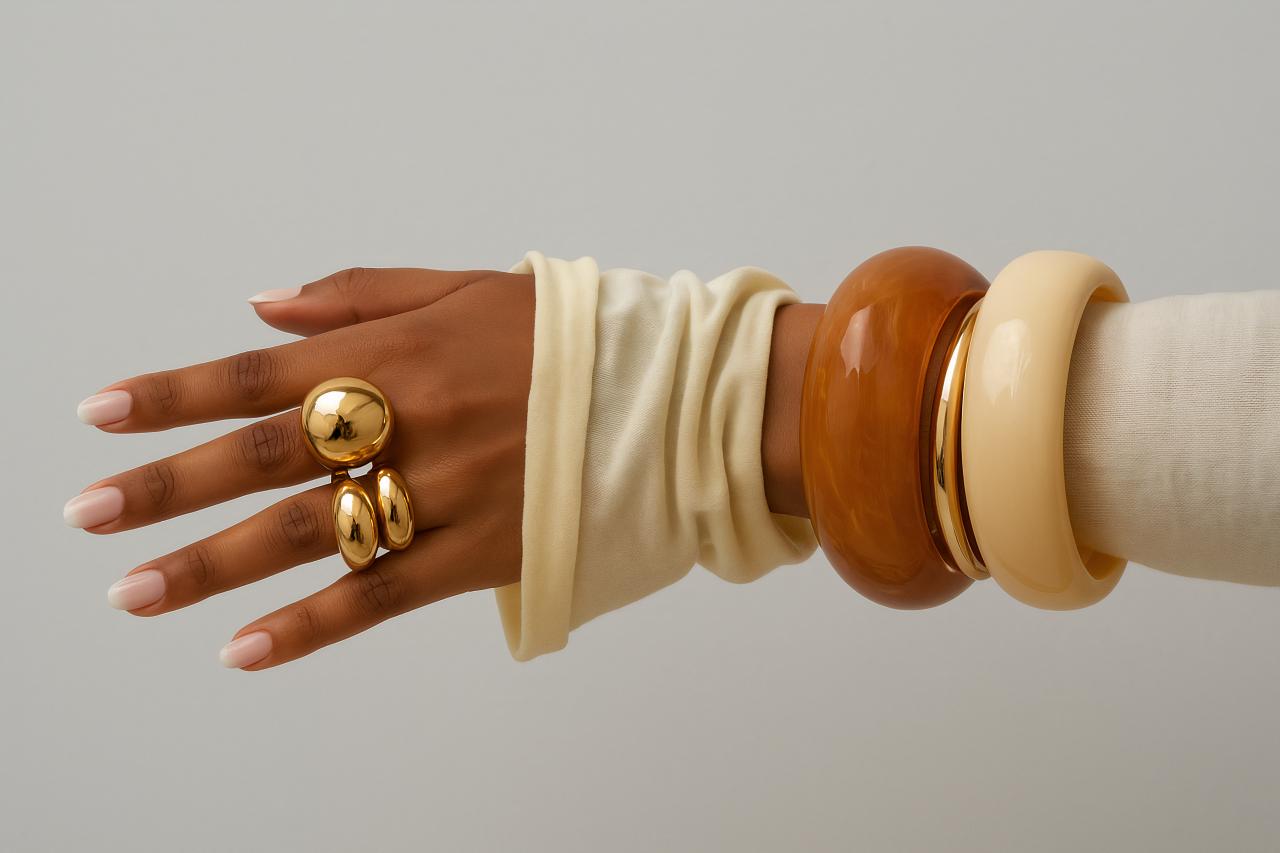 Hand with bracelet, ring, bangle, and sphere jewelry pieces