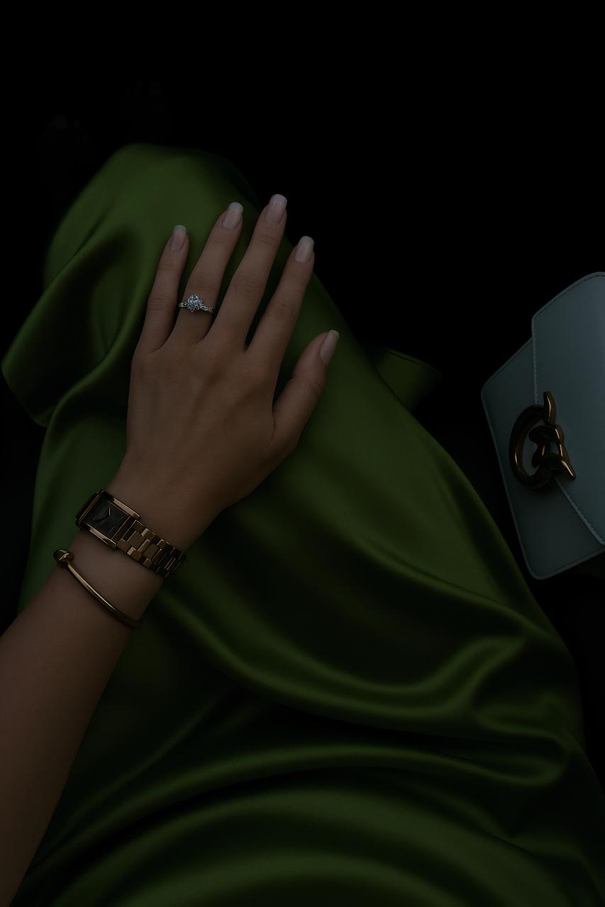 Hand with fashion jewelry accessories including rings, bracelets, and wristwatch