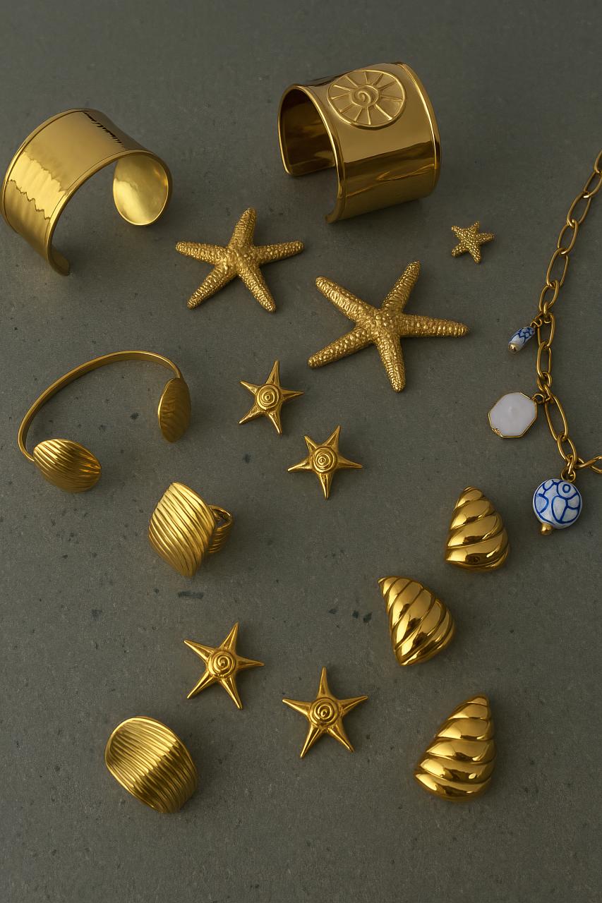Golden starfish earrings, bracelets, and rings on display