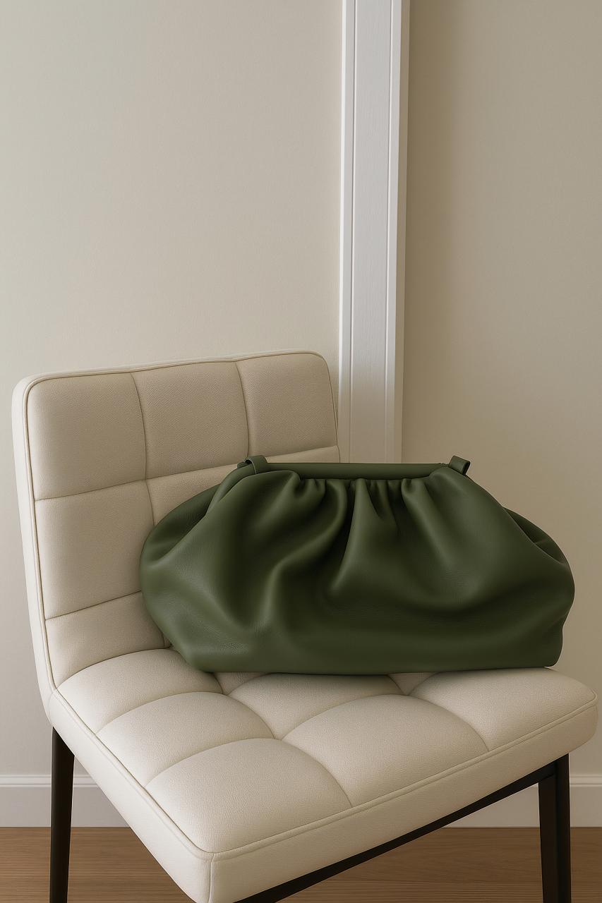 Luxury leather club chair, bag, ottoman in elegant living room