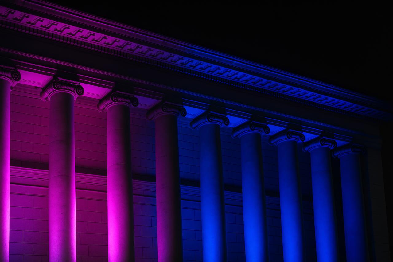 Neon-lit Roman temple column at night
