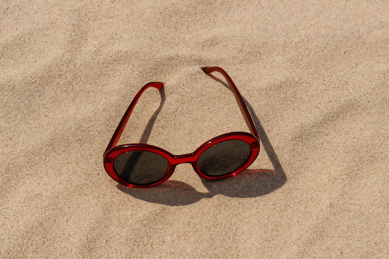 Eyewear on sandy beach background