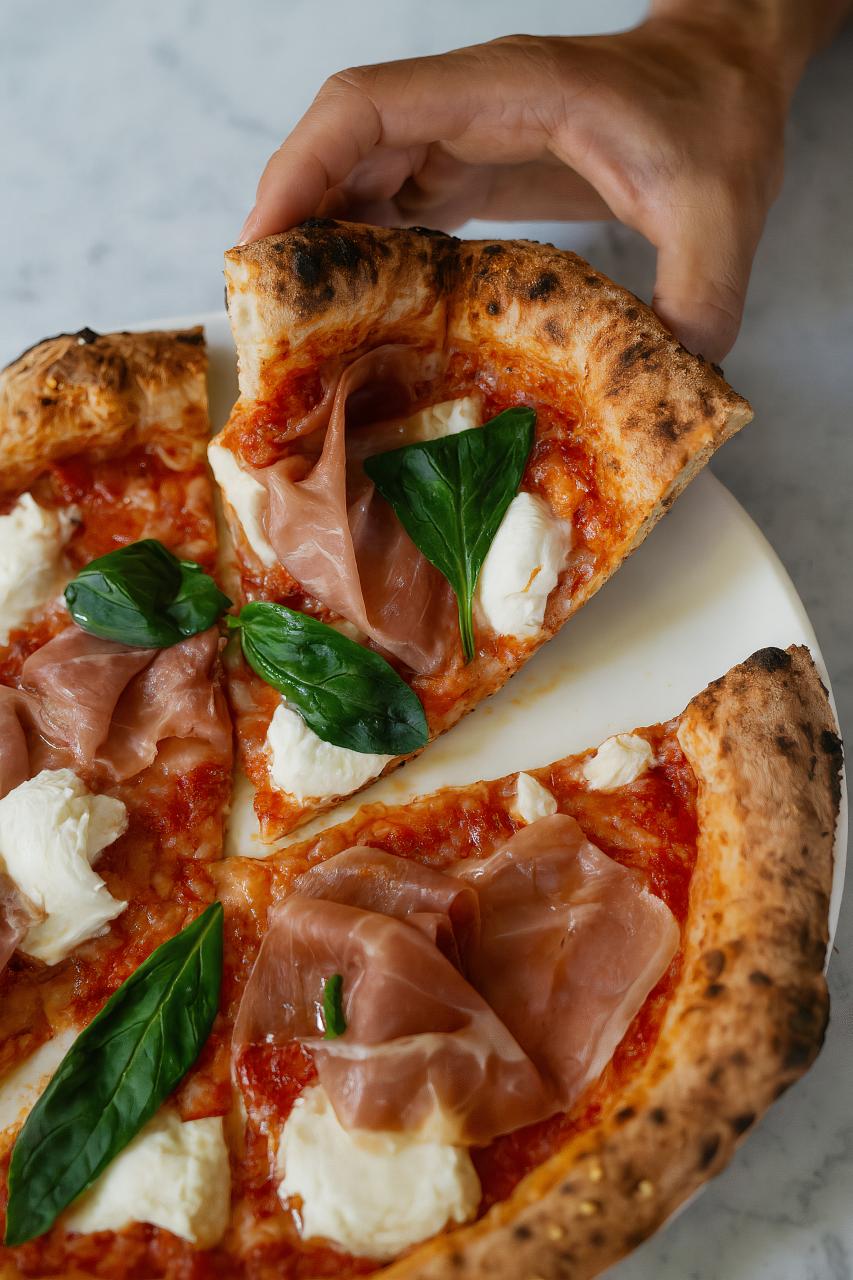California-style pizza with meat, leaf vegetables, and prosciutto
