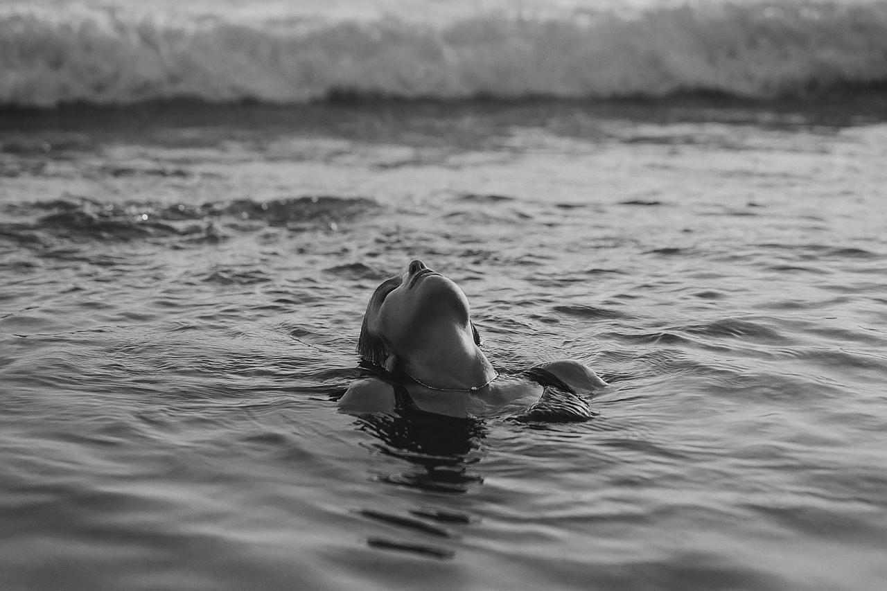 Black and white dolphins swimming in ocean waves