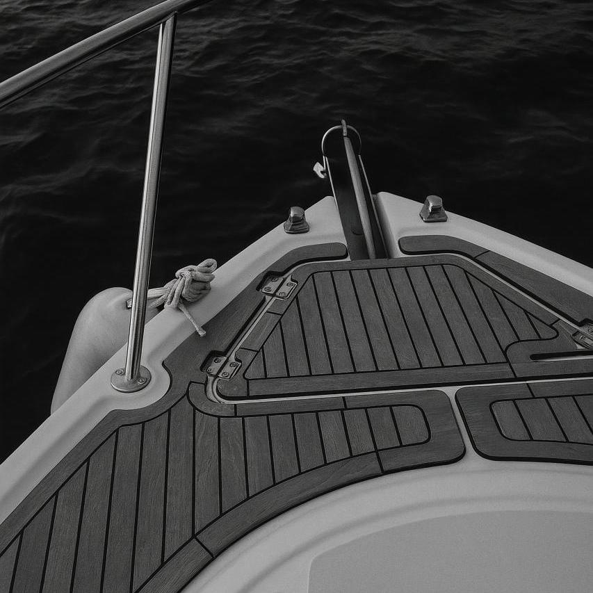 Monochrome boat launch with grey motorboat, rope, and steering wheel