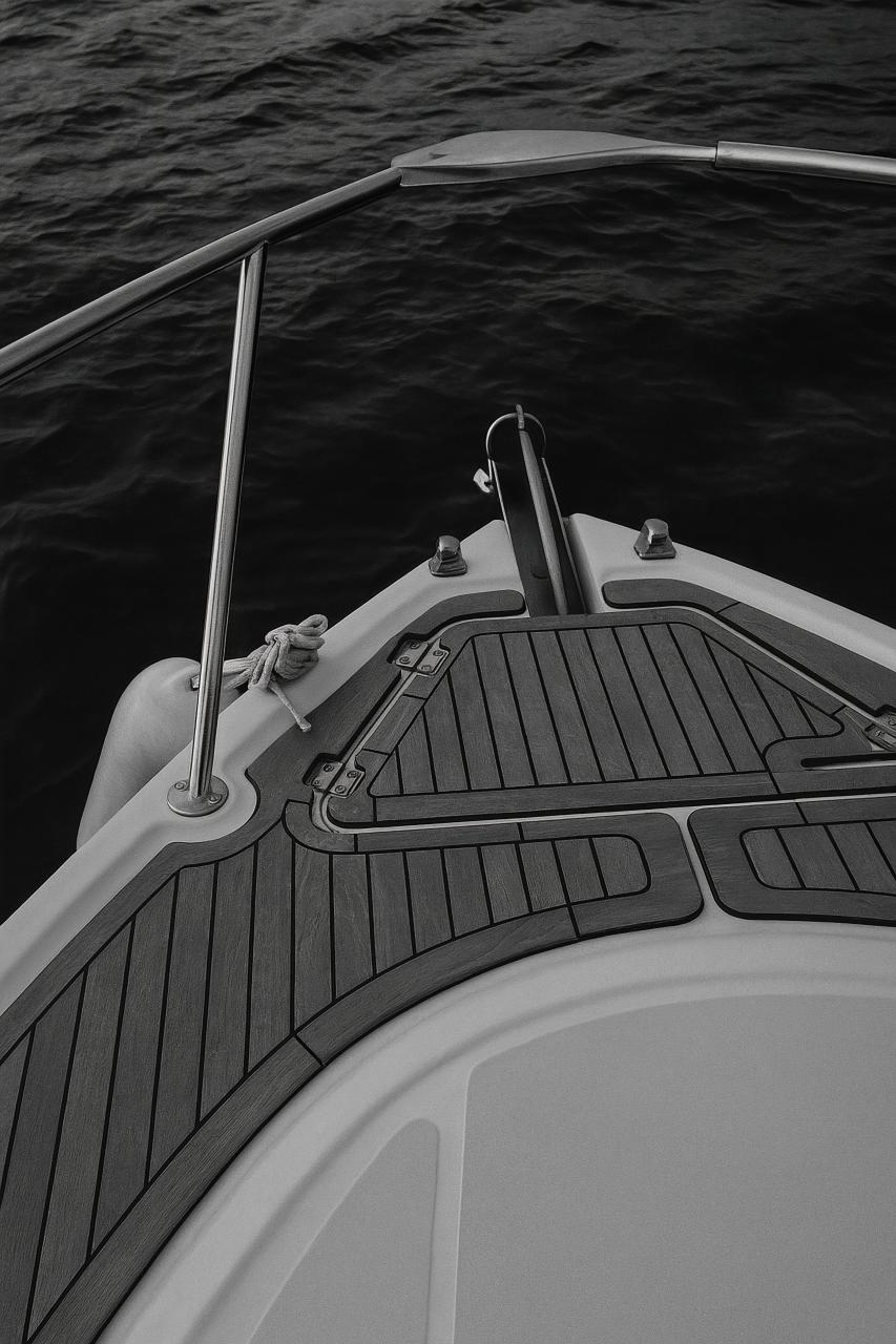 Monochrome boat launch with grey motorboat, rope, and steering wheel