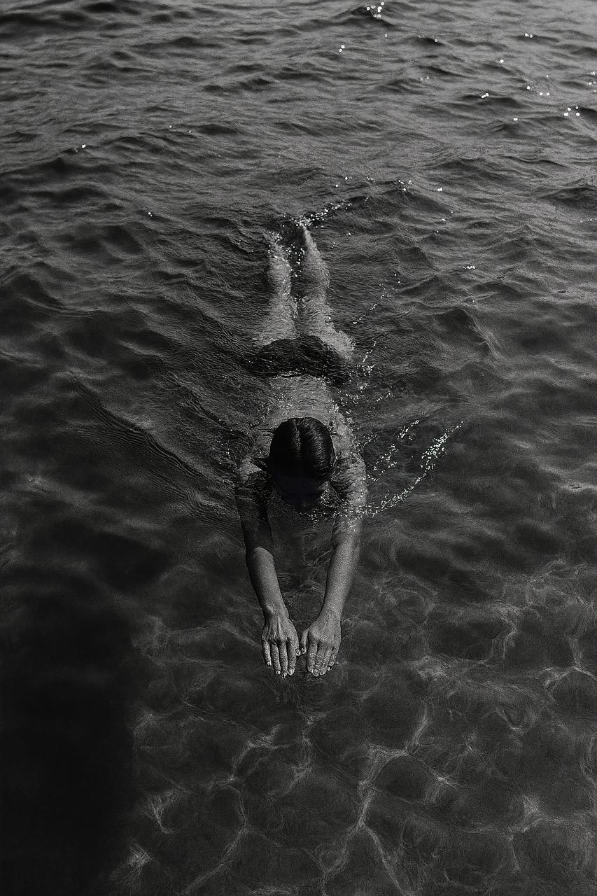 Monochrome open water swimming with reflection