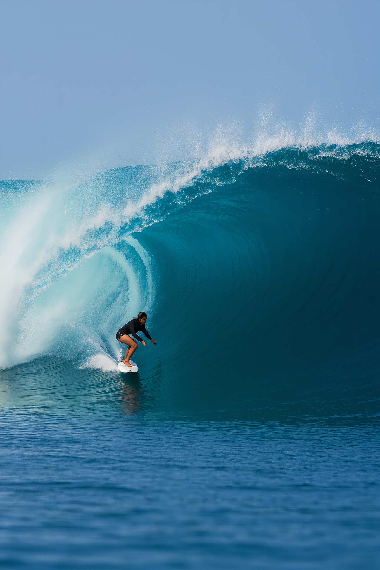 Group of seven surfers riding ocean waves with surfboards