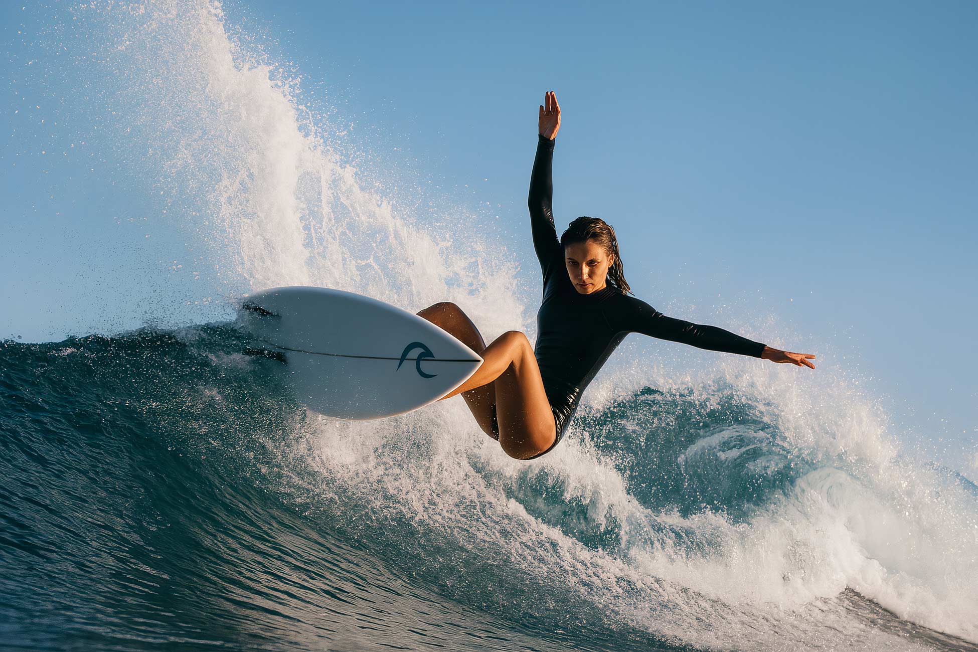 Surfer riding ocean wave on surfboard