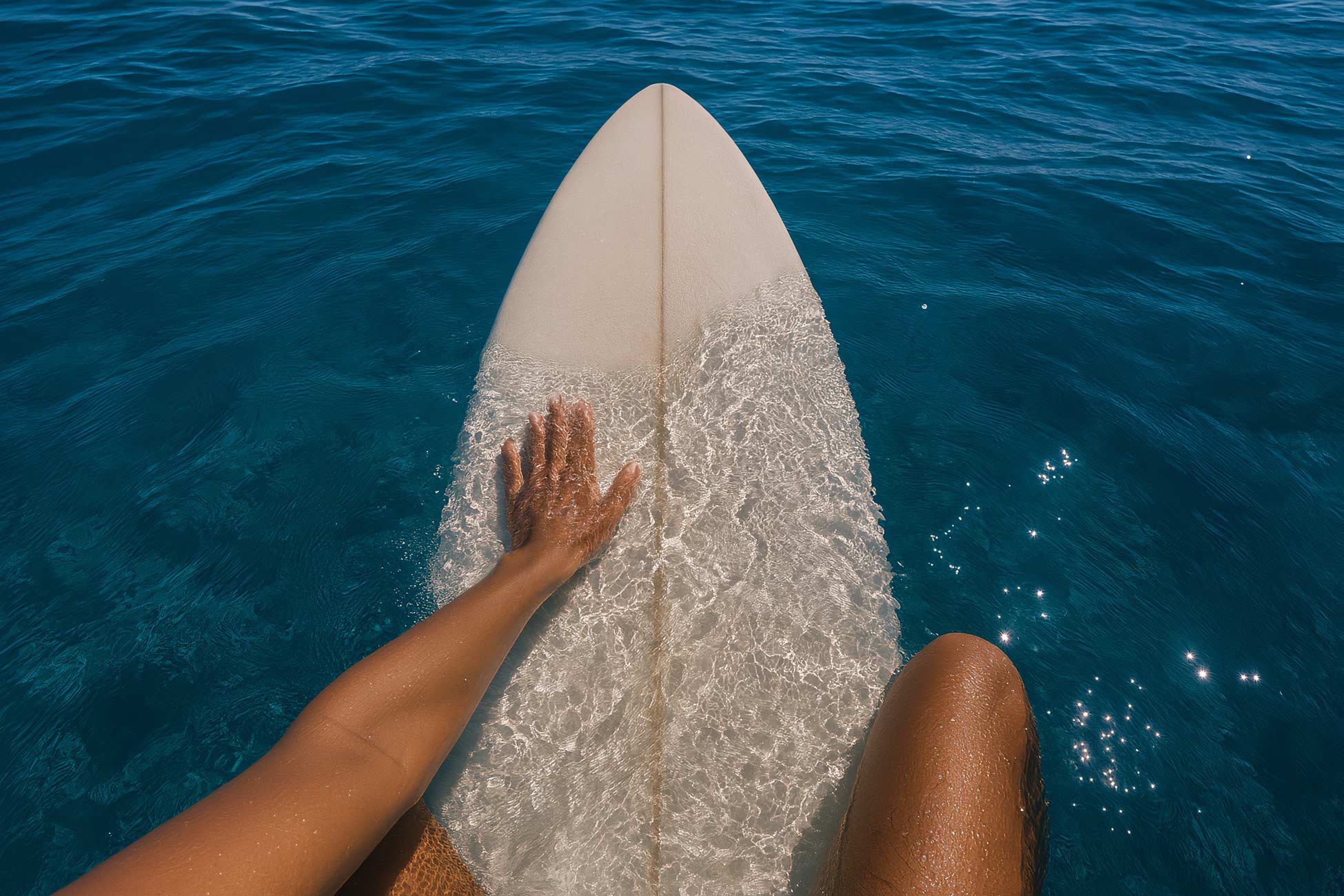 Surfer on wave with surfboard in ocean