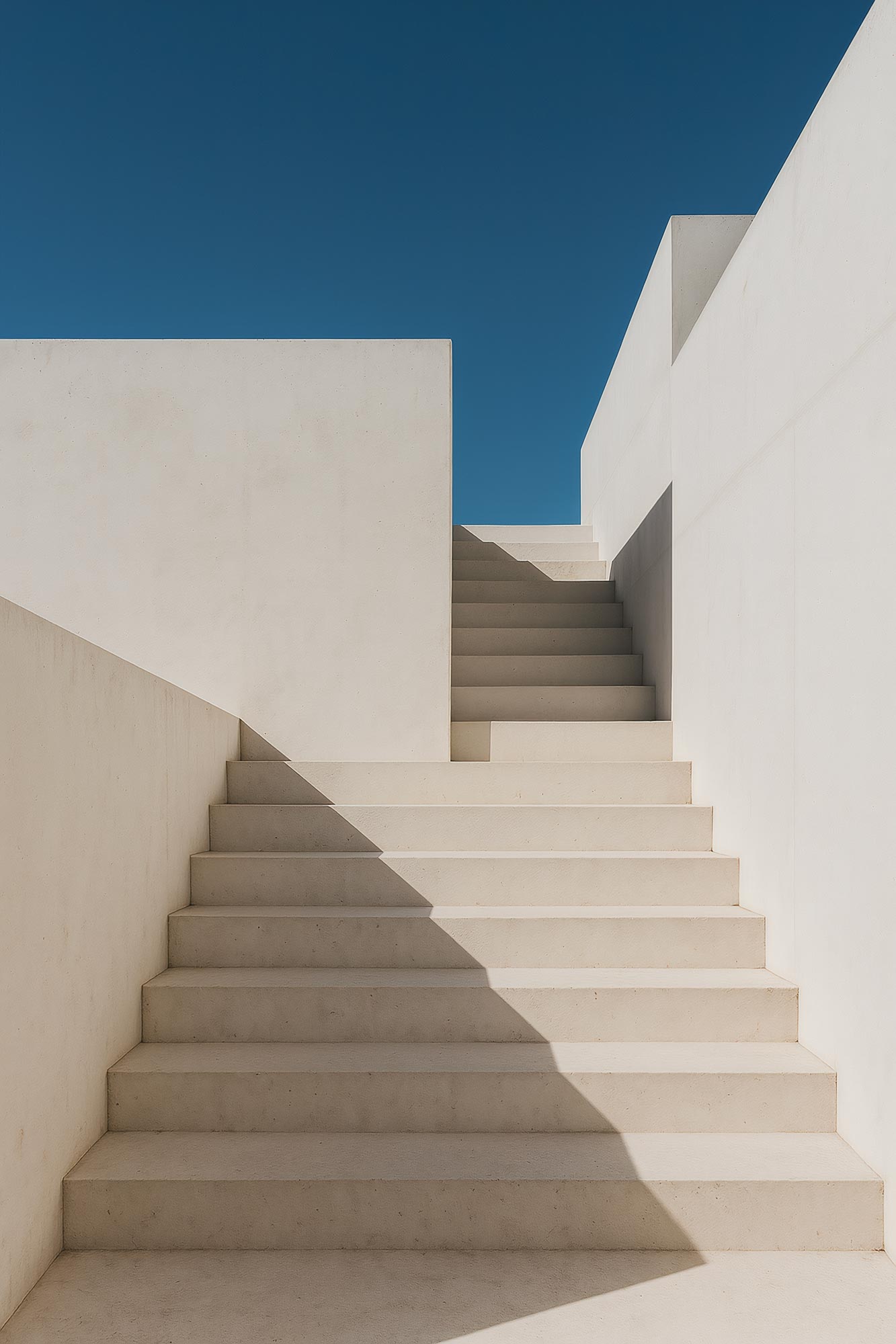 Modern concrete staircase with handrail and shadows