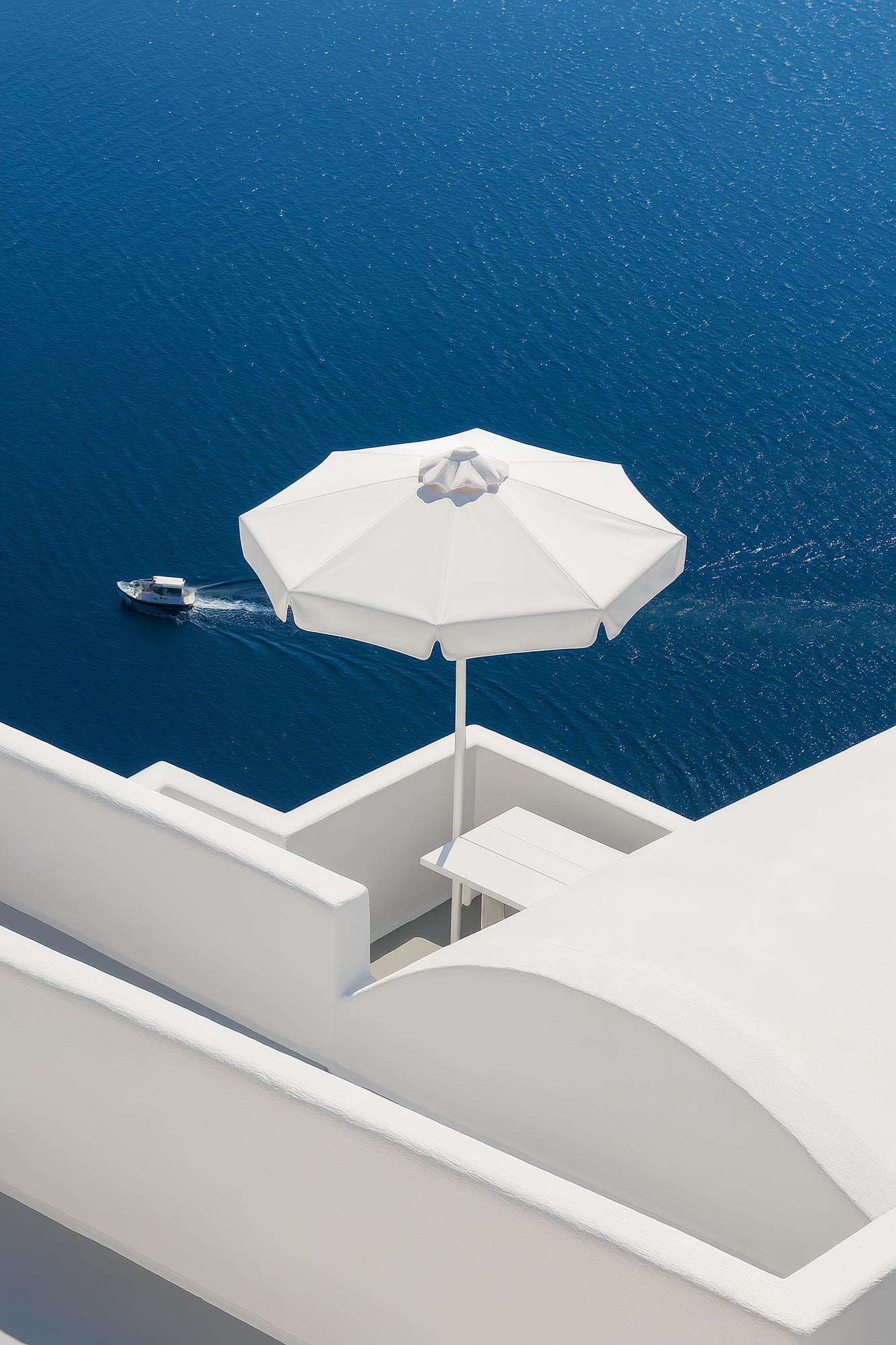 Oceanfront resort with outdoor furniture, sea view, balcony, and umbrellas