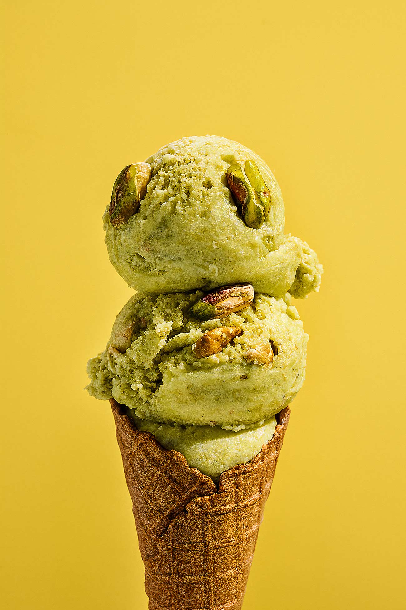 Assorted ice cream cones with pistachios and fruits