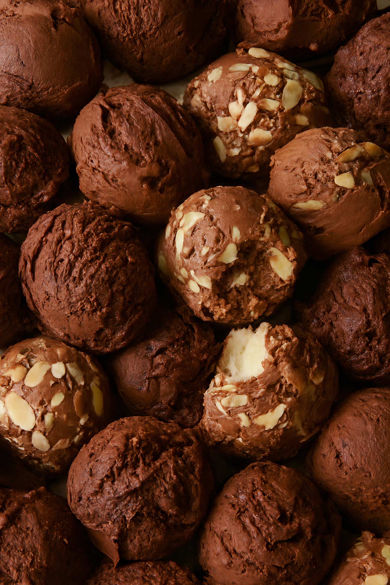 Assorted chocolate truffles and bourbon balls on wooden table