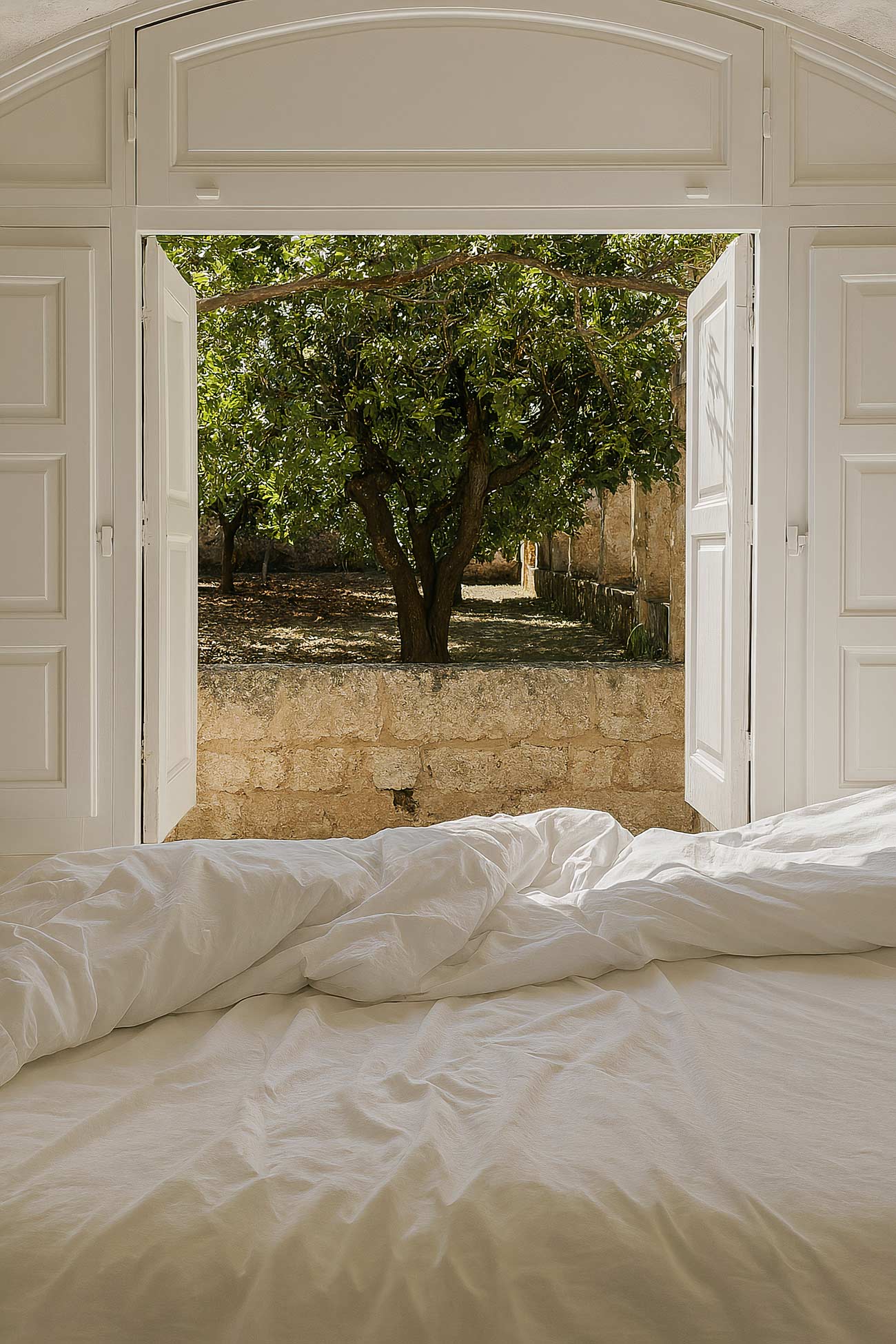 Bedroom with wood bed frame, bedding, pillows, and sofa