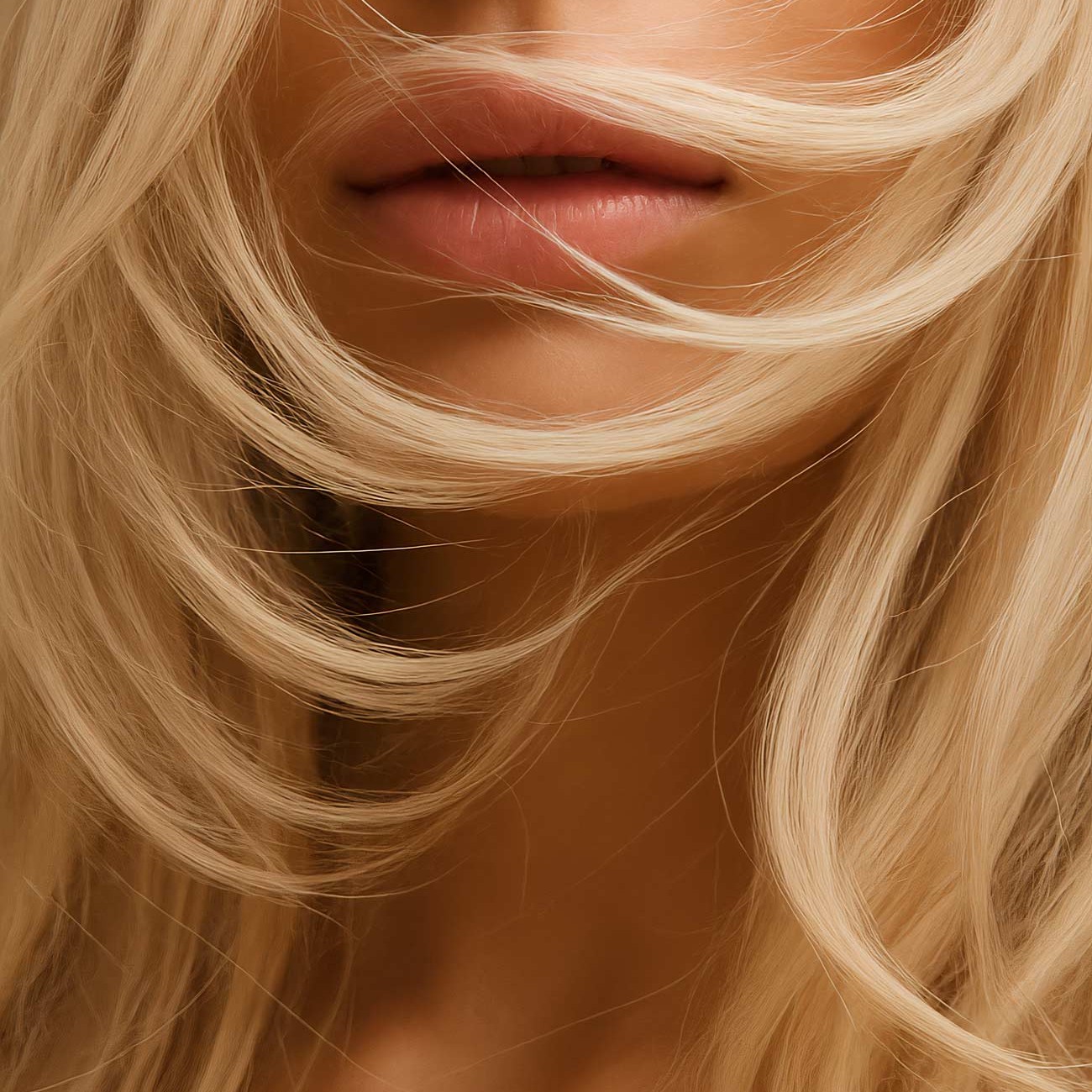 Blond woman with brown eyes and layered hairstyle in close-up portrait