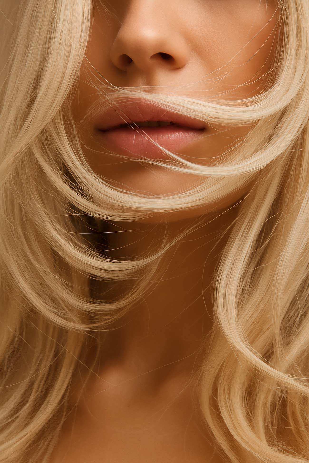 Blond woman with brown eyes and layered hairstyle in close-up portrait