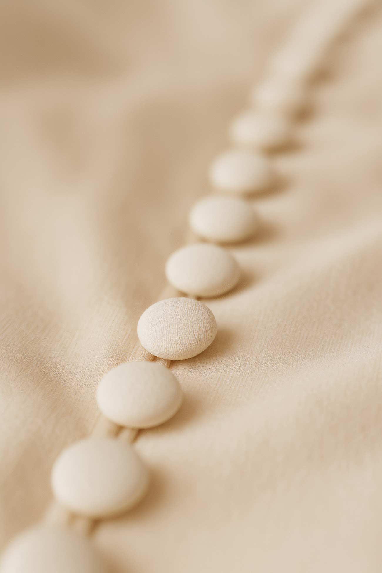 Silk button with detailed stitch in close-up view