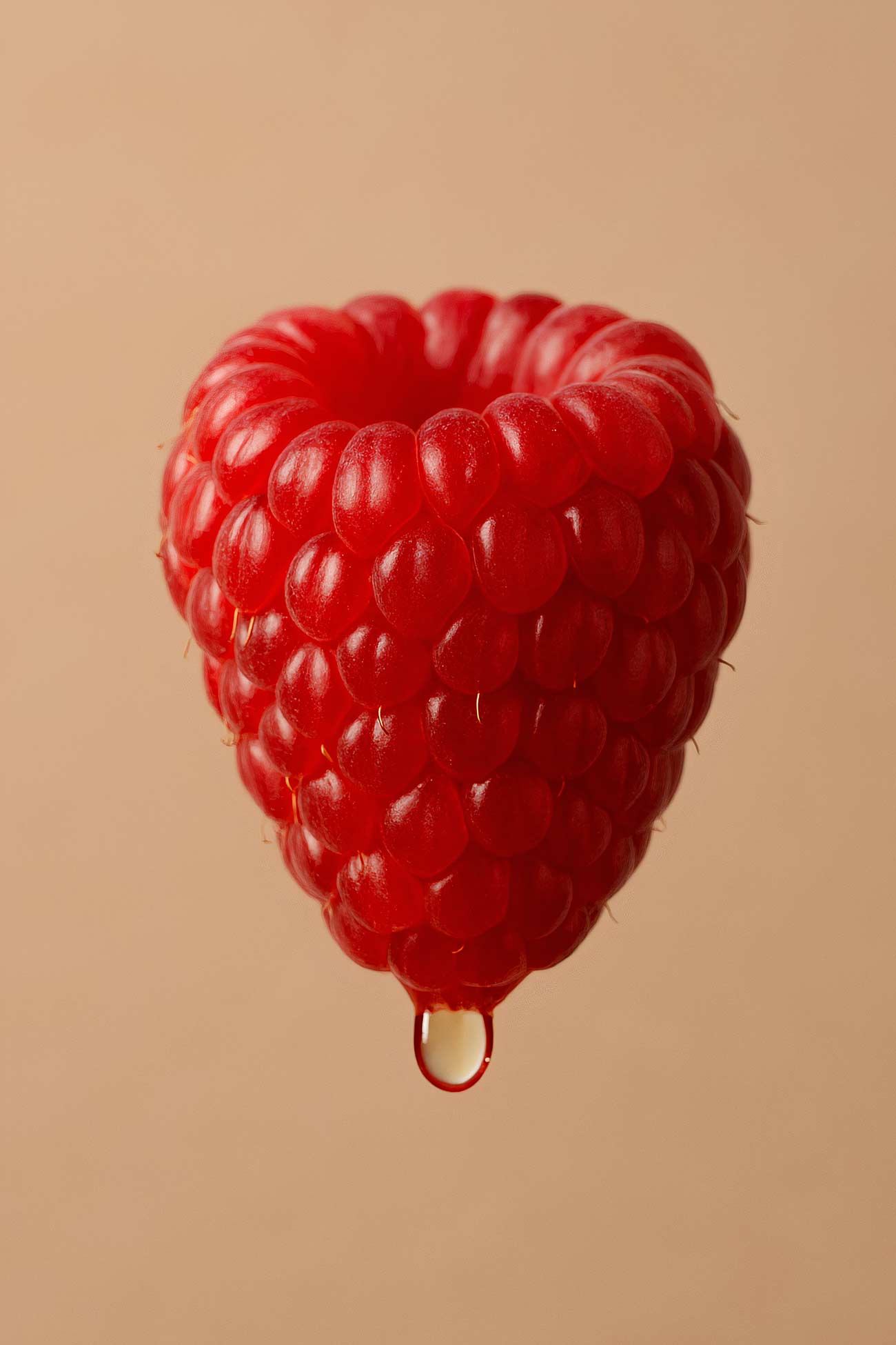 Raspberry wine heart still life photography showcasing vibrant red berries and natural textures