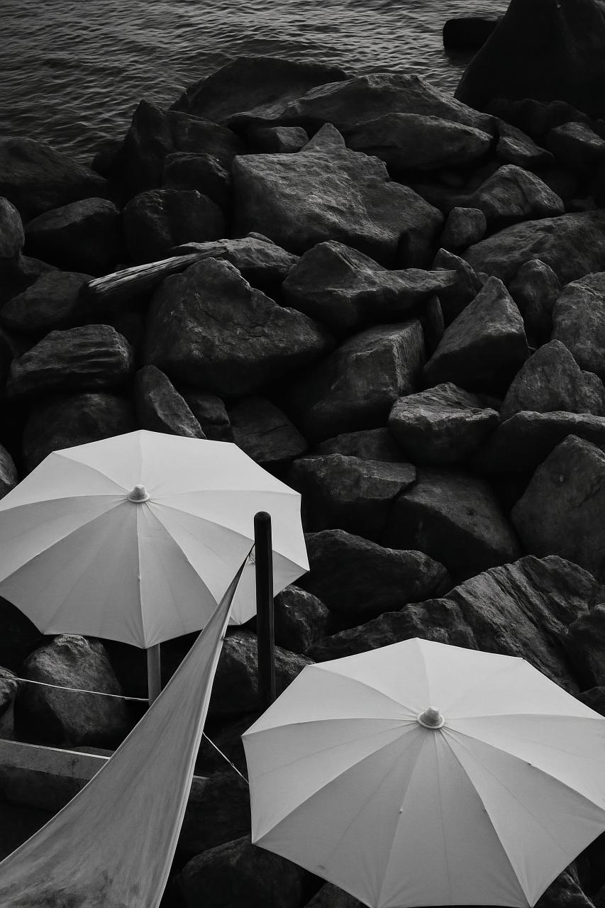 White umbrella on beach by the sea
