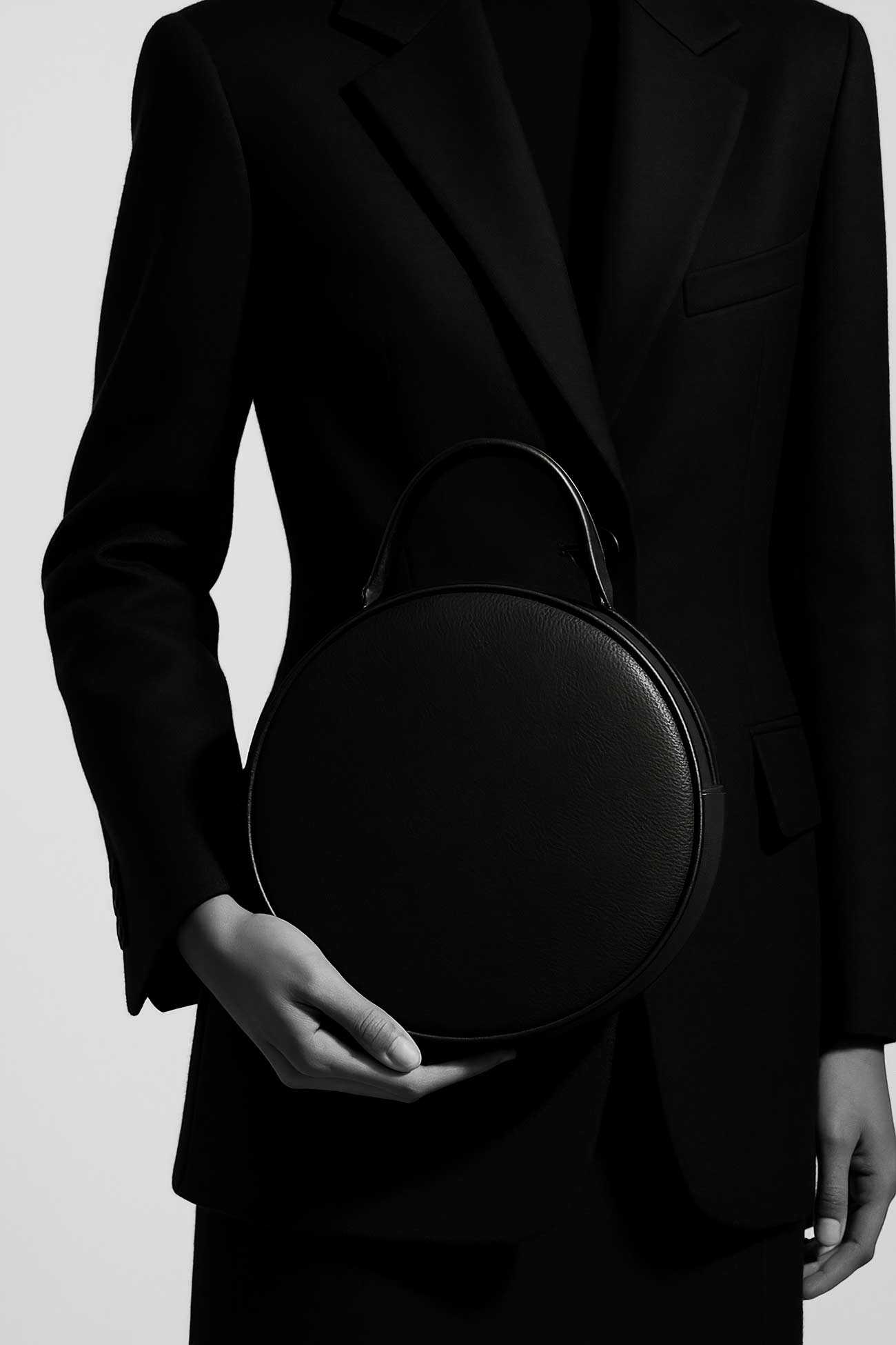 Black leather shoulder bag with strap and zipper