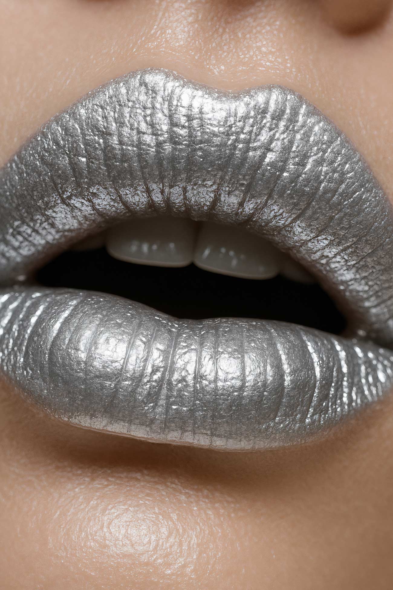Close-up silver lip care cosmetics with lipstick, lip gloss, and lip balm