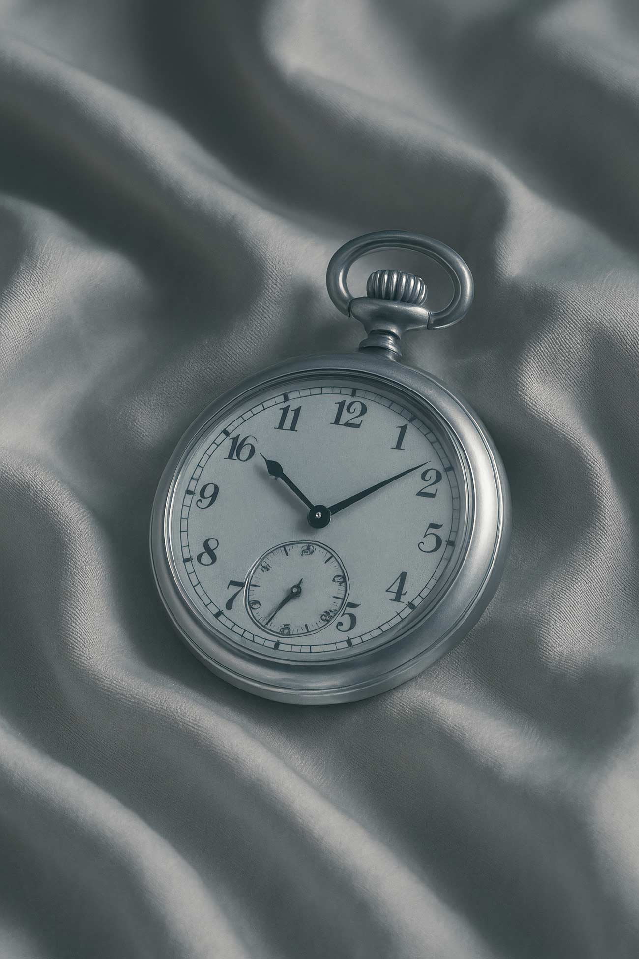 Silver pocket watch and quartz clock in still life photography