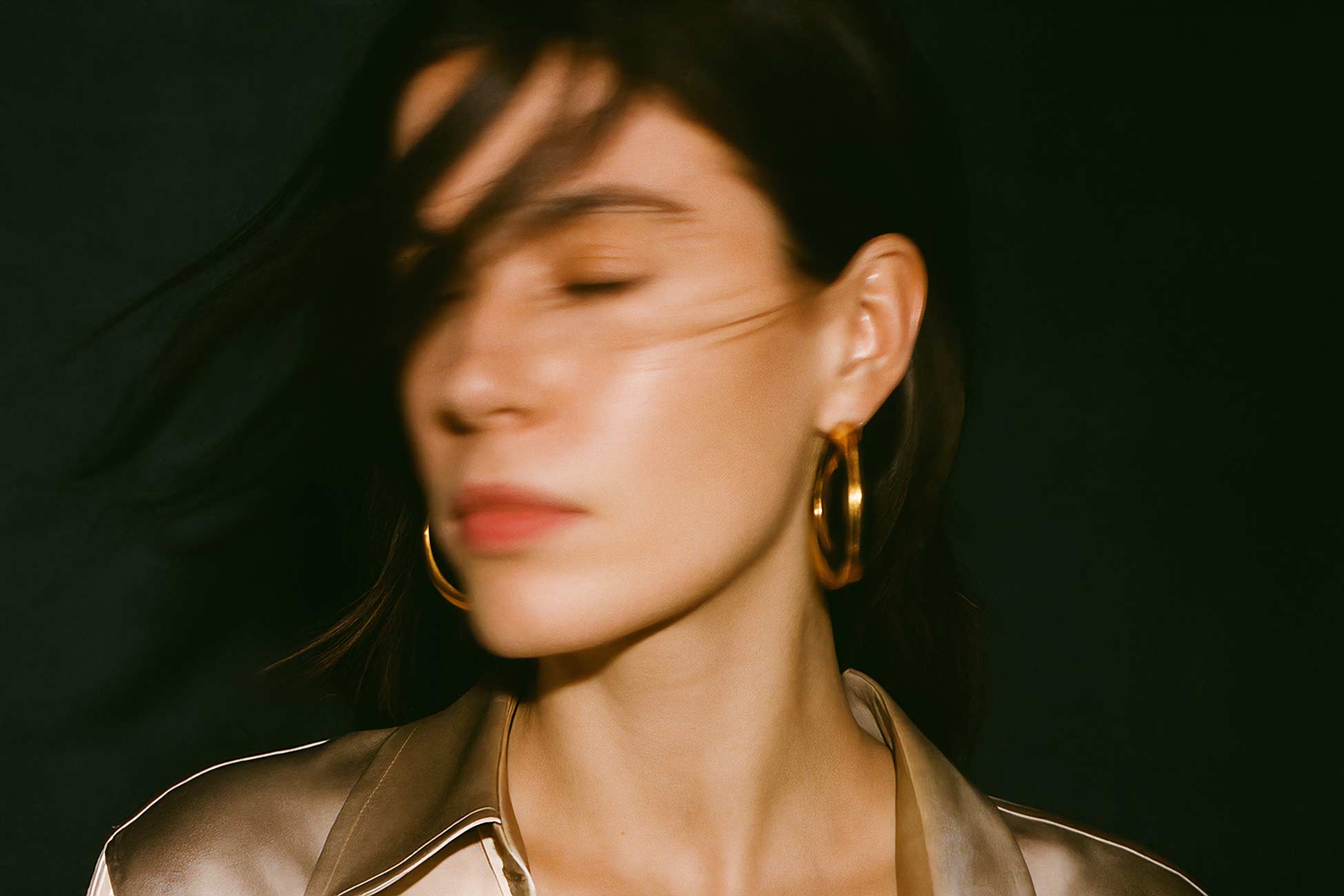 Girl with black hair, stylish earring, and fashionable makeup
