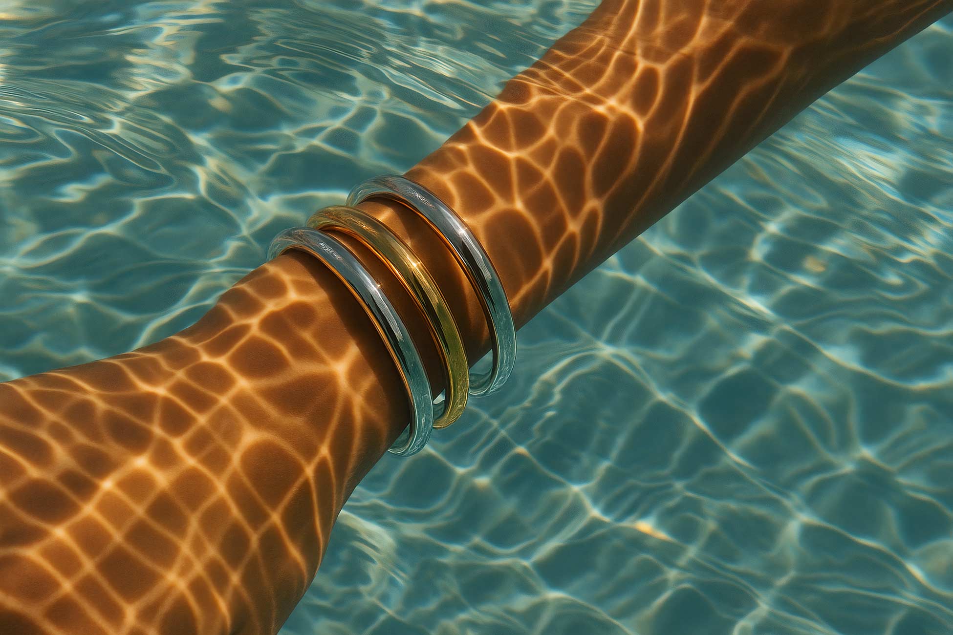 Silver bangle bracelet on hand by swimming pool