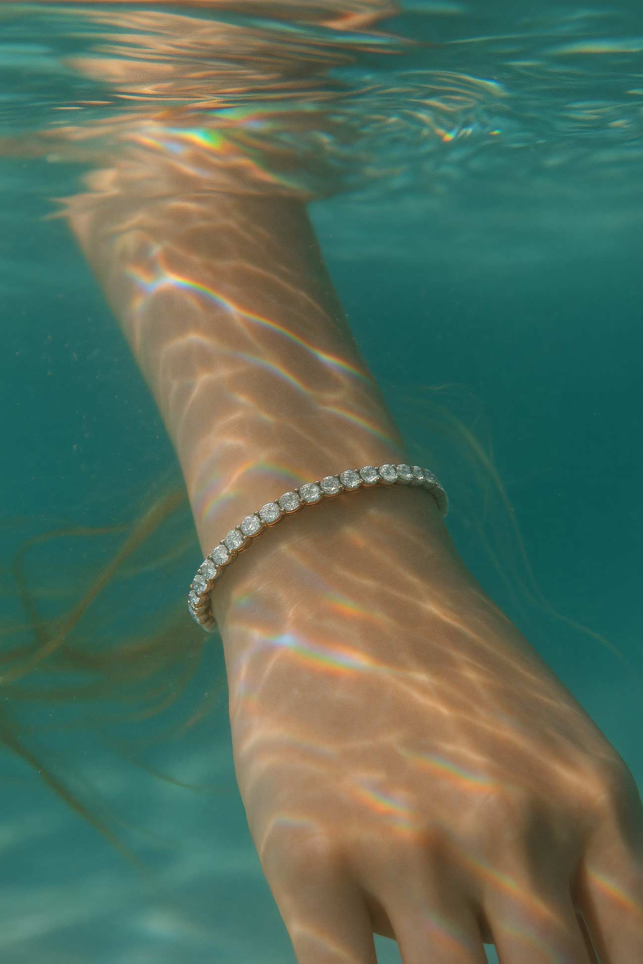 Silver bracelet on underwater wrist