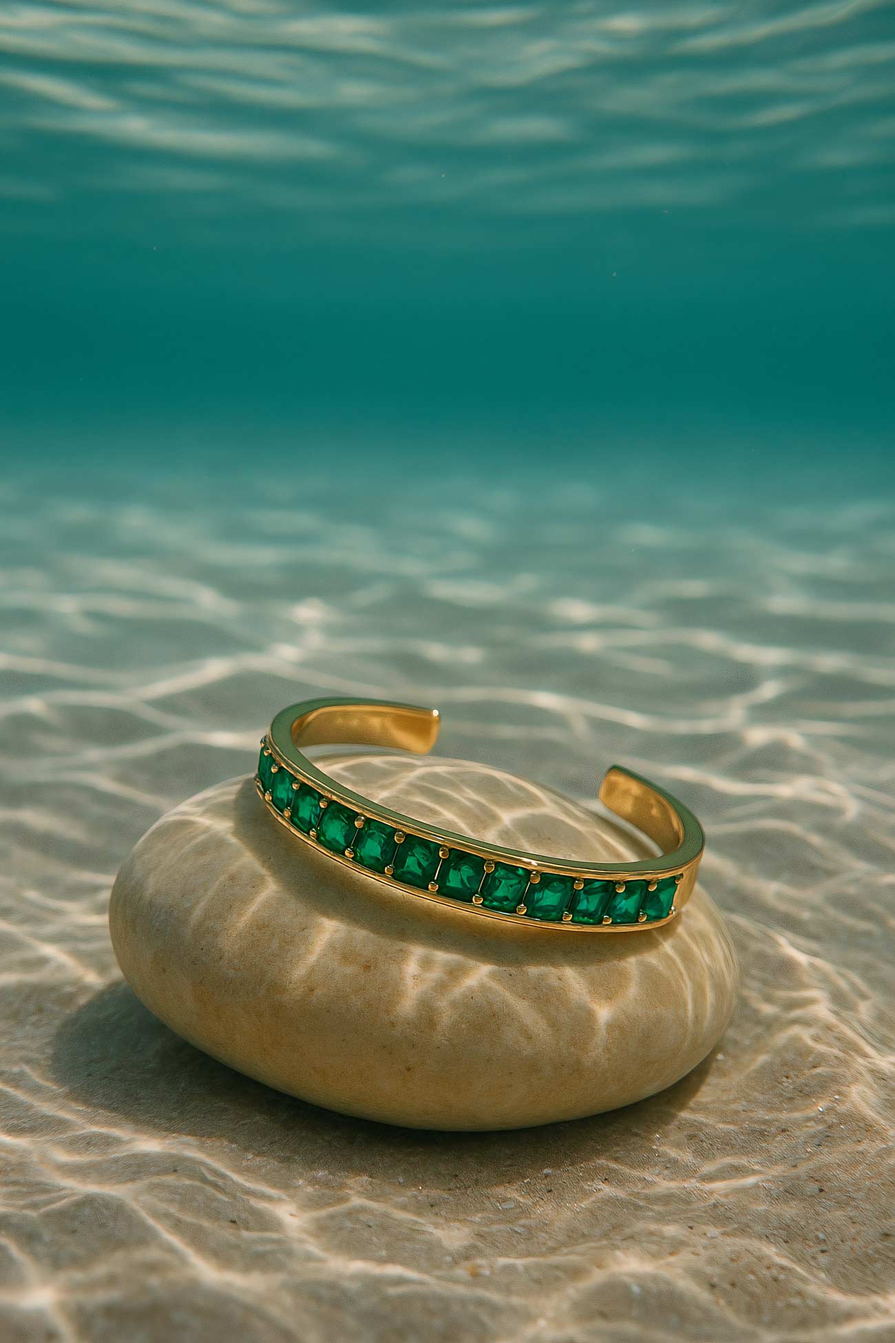 Turquoise and emerald gemstone jewelry on blue background