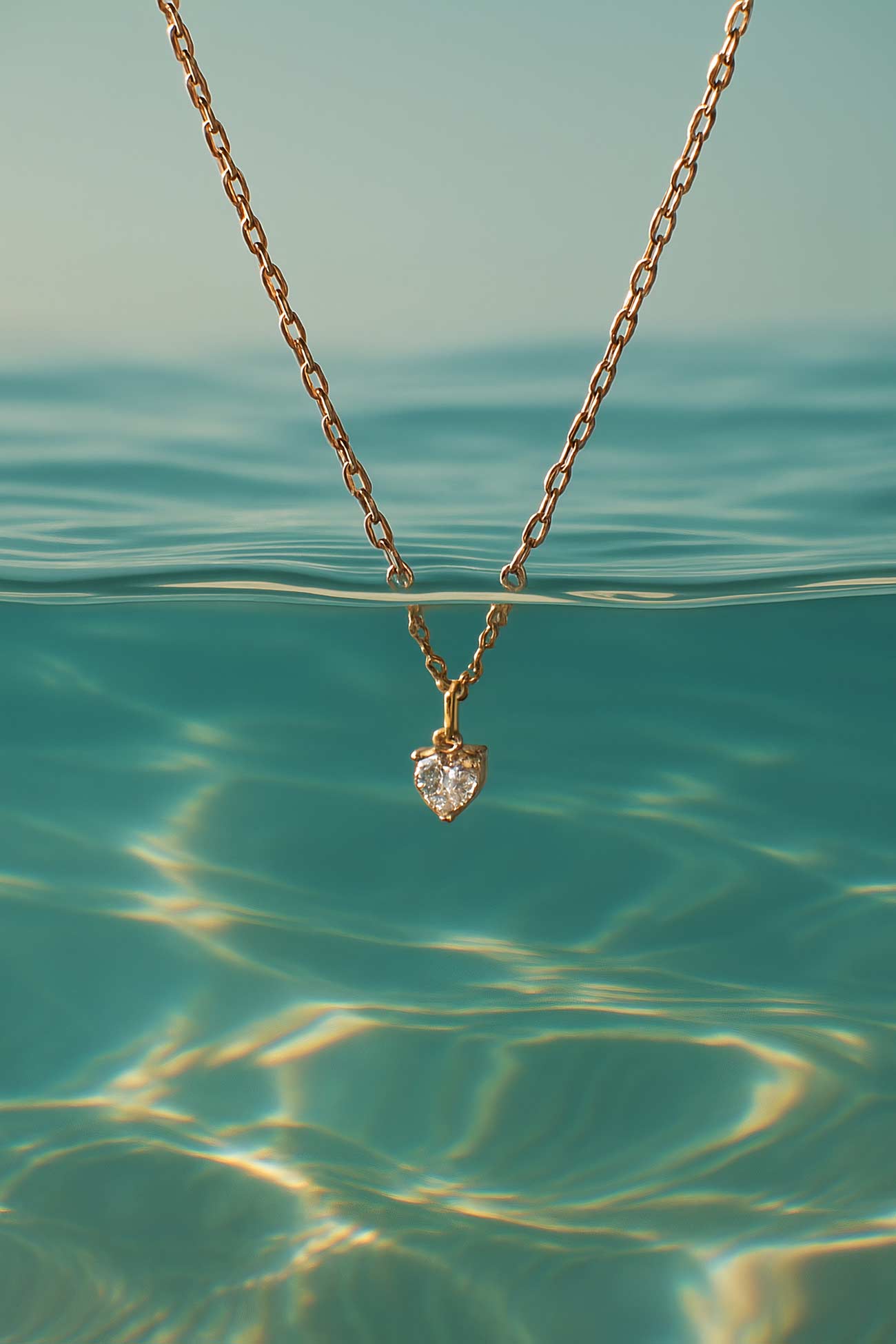 Gold pendant necklace with intricate chain details