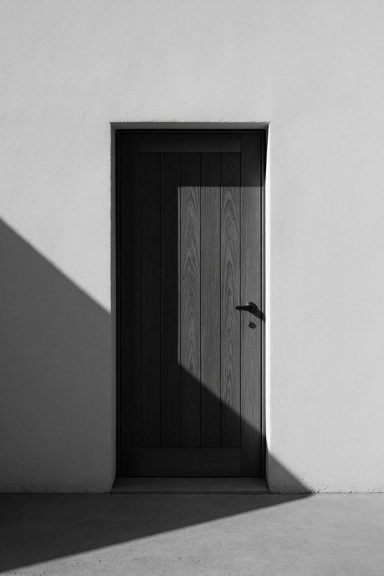 Monochrome wall design featuring white wood, black composite material, and grey concrete